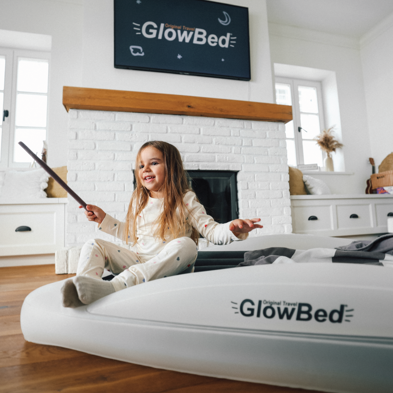 Child sitting on The Shrunks GlowBed travel bed
